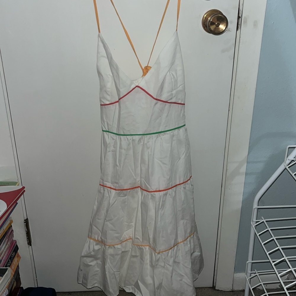 Adjustable straps with a tie in the back. White with multicolored stripes